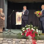 burmistrz i wiceburmistrz wręczają malowidło dla dyrektor